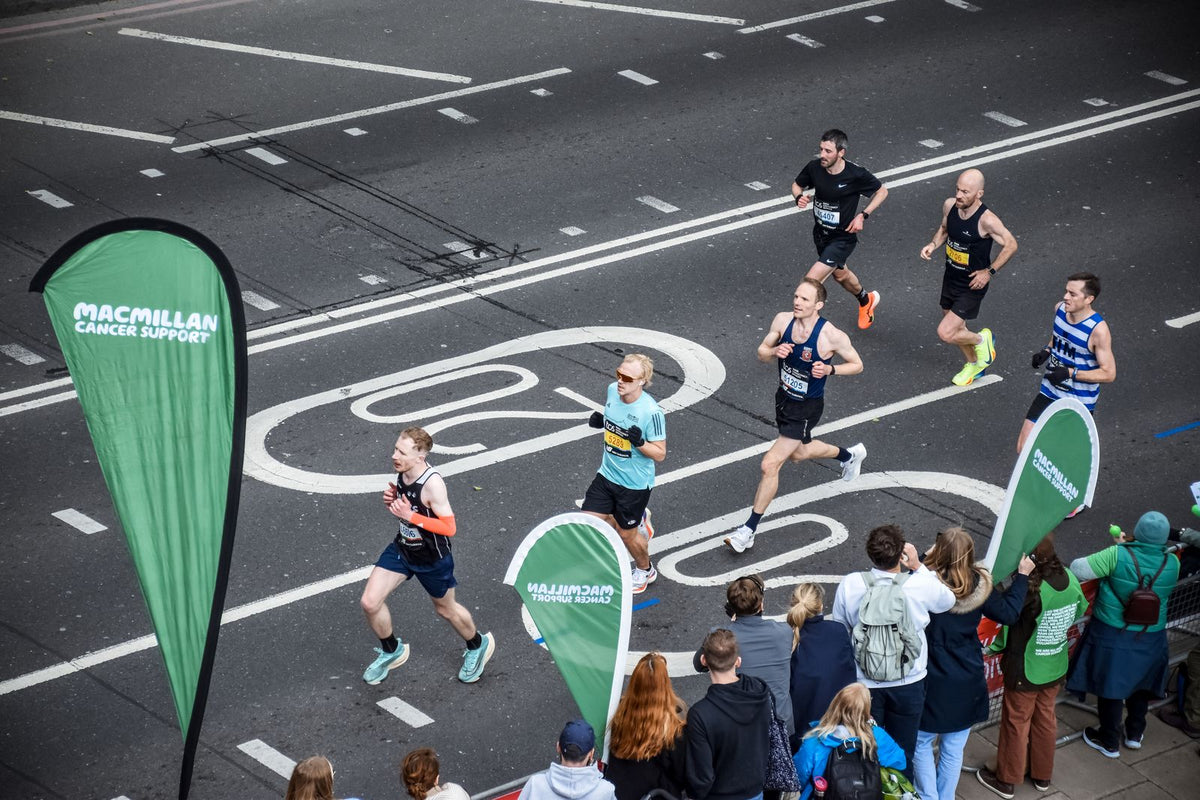 A large pack of runners participating in a city marathon