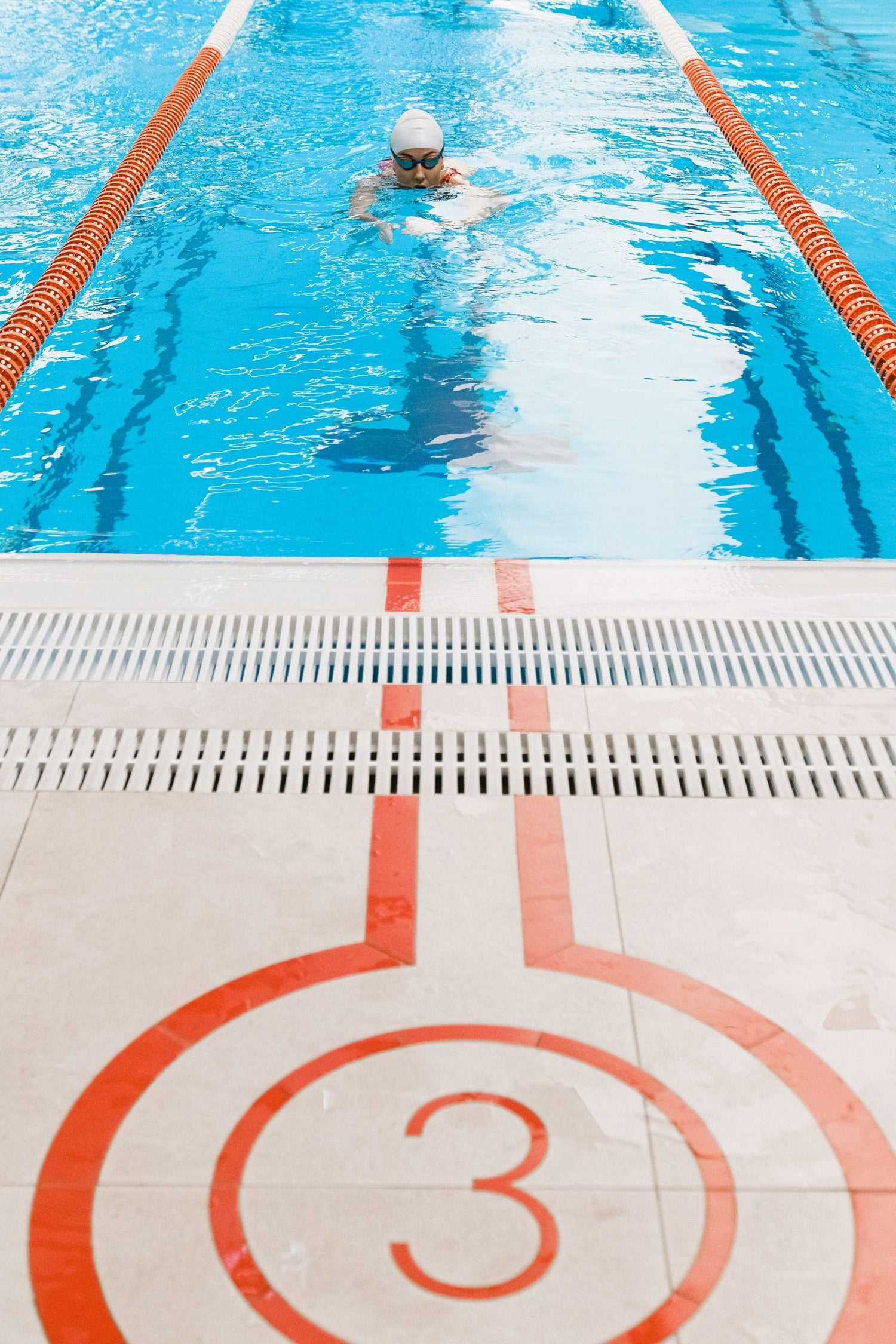 Swimmer training in a marked indoor pool lane