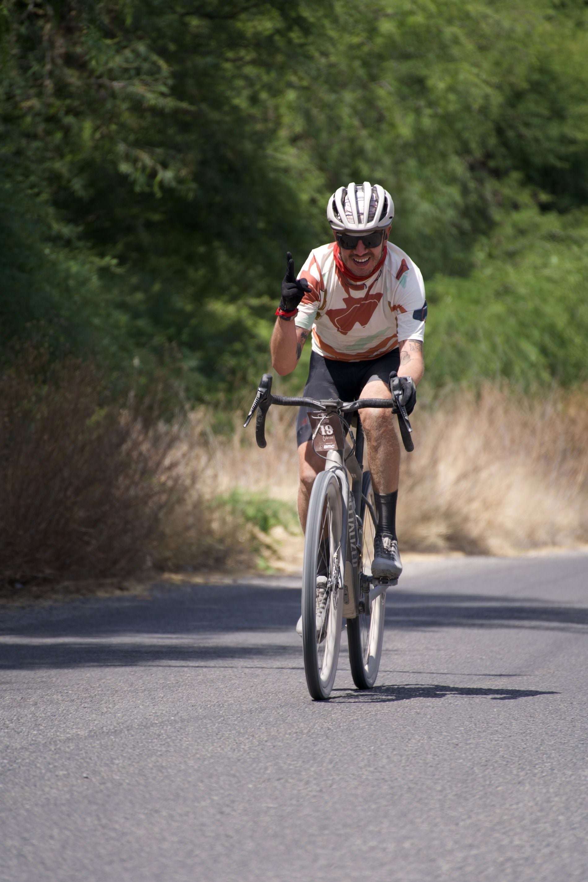 Road cyclist training outdoors while monitoring effort