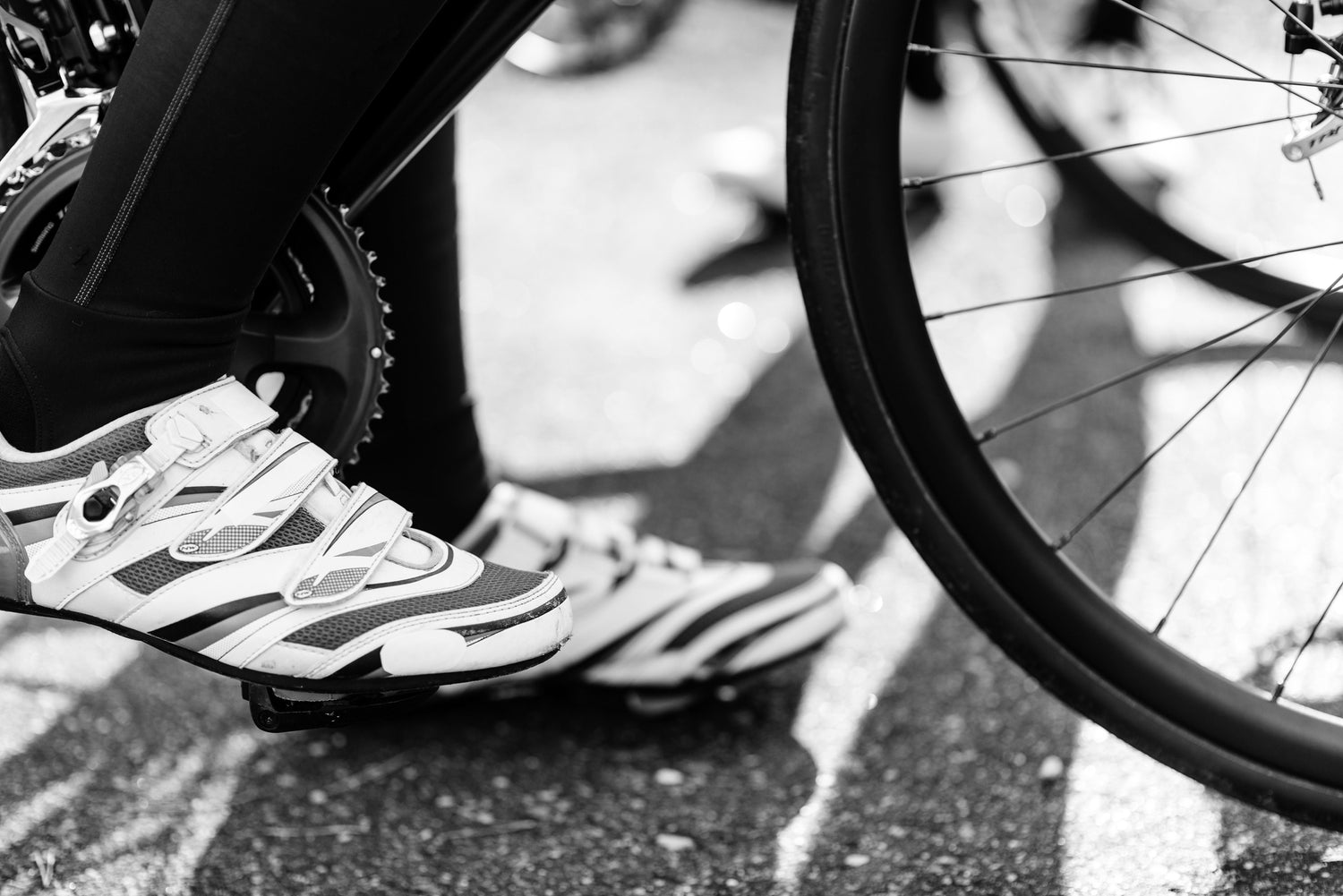 Close-up of a cyclist's shoe clipped into a road bike pedal