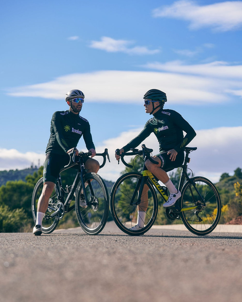 Cyclists riding together at a relaxed pace on a quiet road