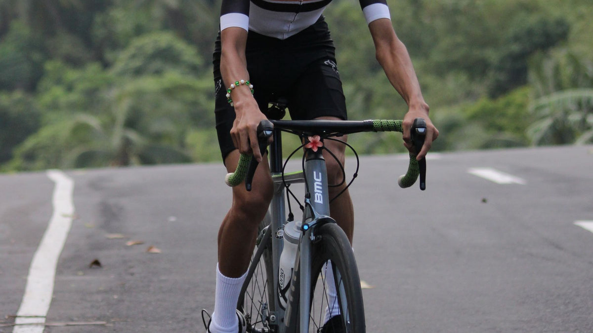 New triathlete descending a winding road while practising bike handling skills