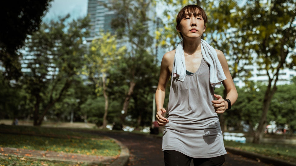 Runner completing a steady training run in a sunny park