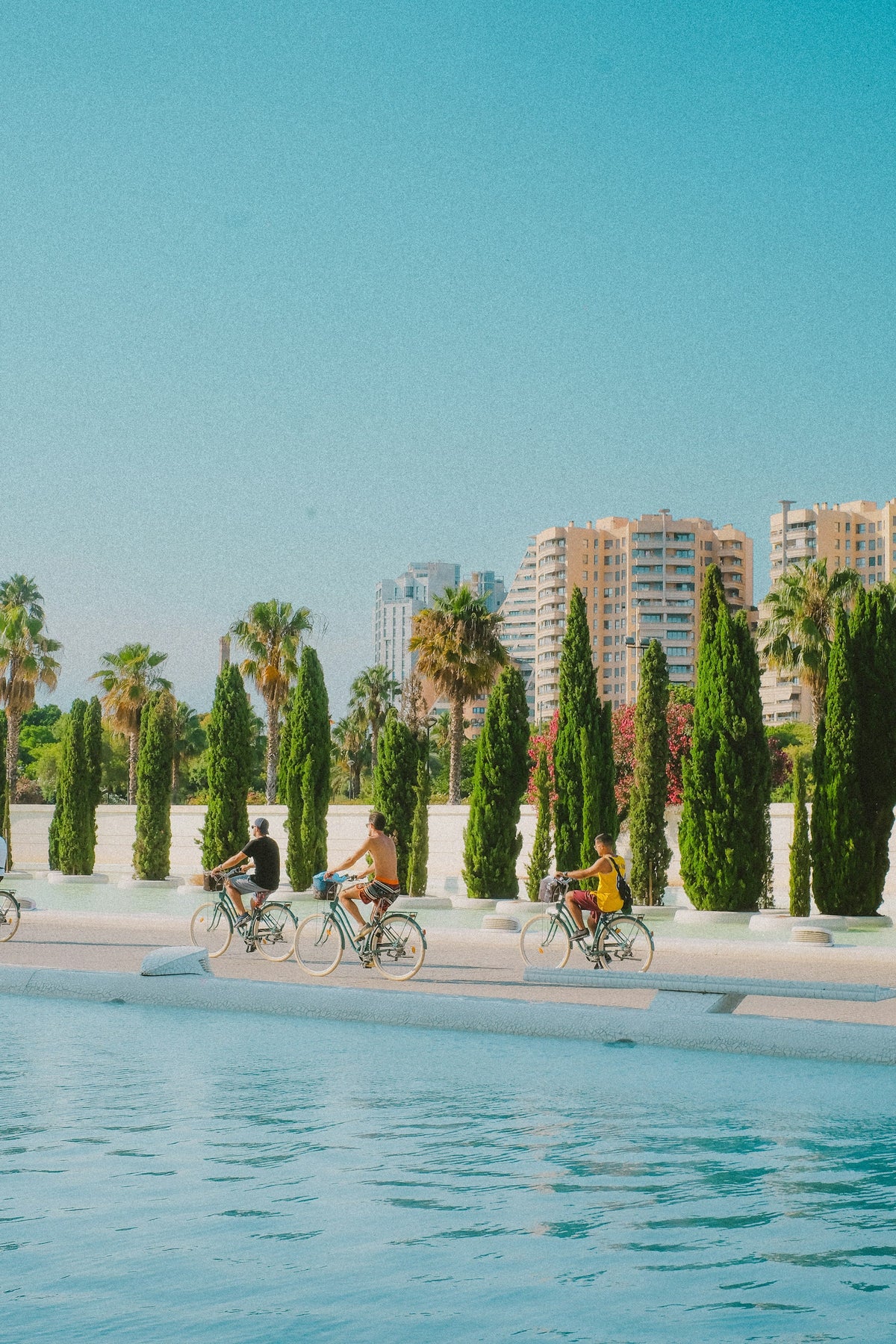 Cyclists beside the City of Arts and Sciences in Valencia, Spain