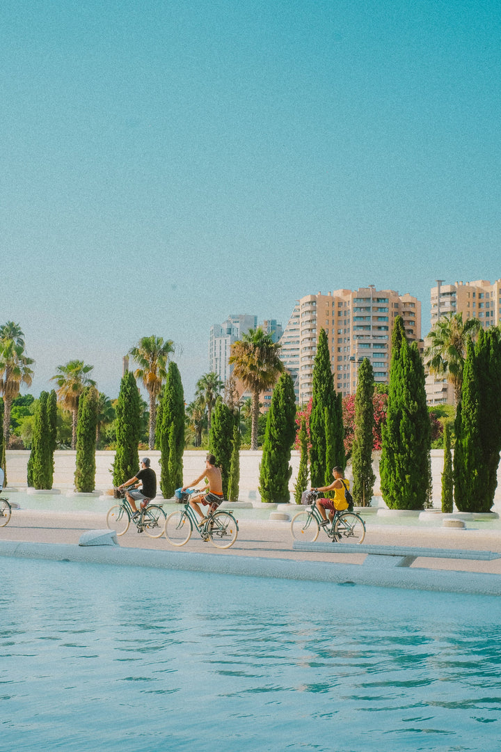 Cyclists beside the City of Arts and Sciences in Valencia, Spain