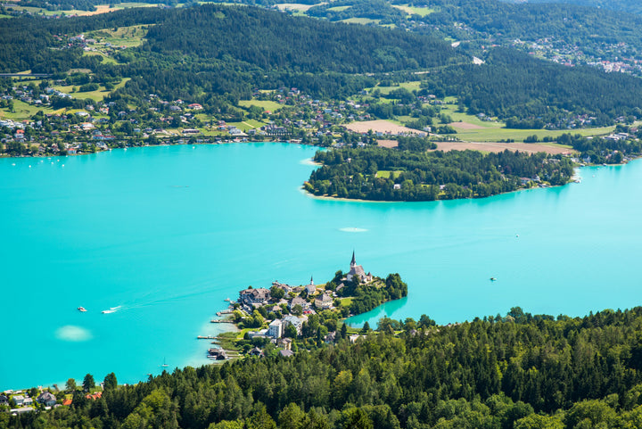 Aerial view of turquoise Lake Wörthersee and the Carinthian wooded hills, Austria, host region of IRONMAN Kärnten-Klagenfurt.