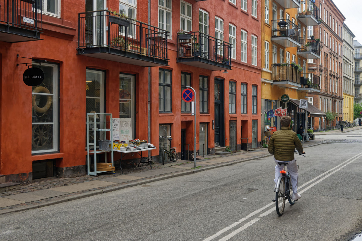 Cyclist riding through a Copenhagen street, Denmark