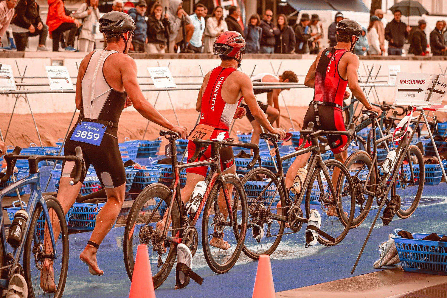 Triathletes preparing bicycles in a race transition zone