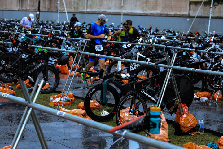 Triathletes moving through a bicycle transition zone during a race