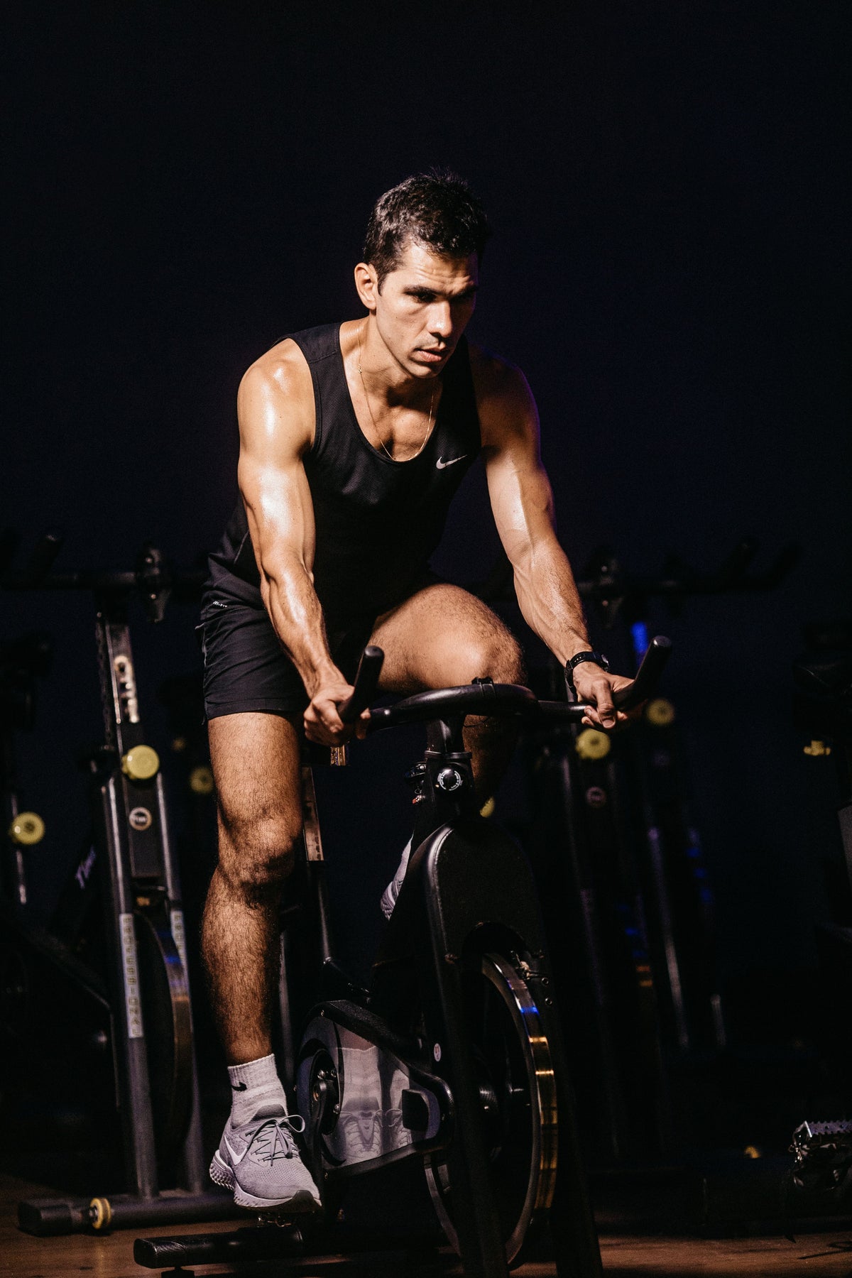 Endurance athlete completing an indoor cycling workout during triathlon off-season training