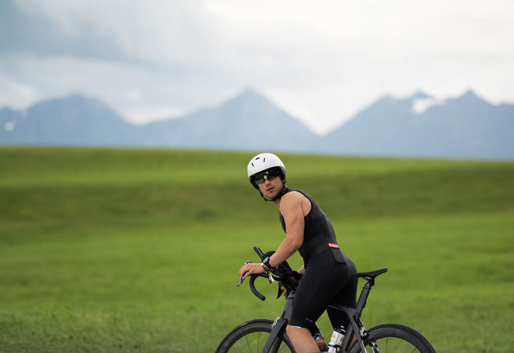 Cyclist riding a time trial bike with aero extensions on a mountain road