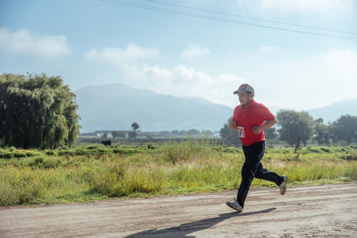 Runner training on a rural road for a running economy and endurance performance guide