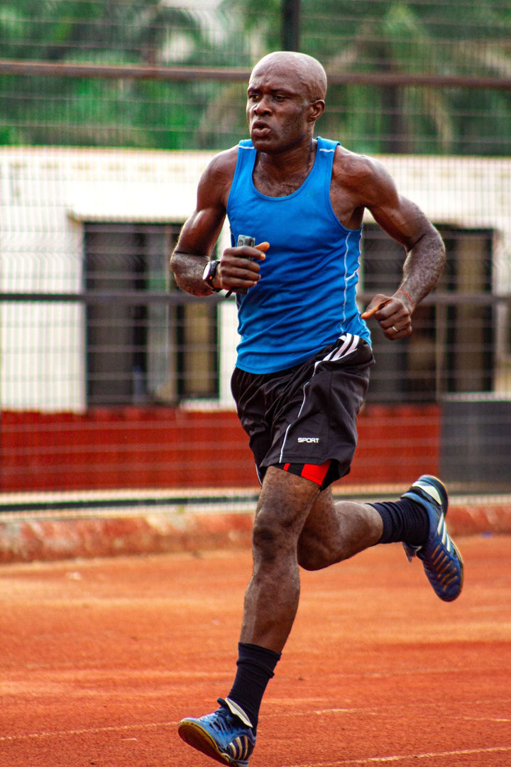 Runner performing hard intervals on an outdoor track for a VO2 max training and age-reference guide