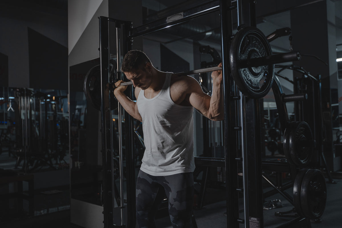 Athlete performing a barbell squat during strength training in a gym