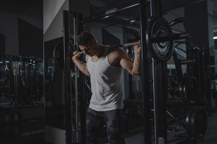 Athlete performing a barbell squat during strength training in a gym