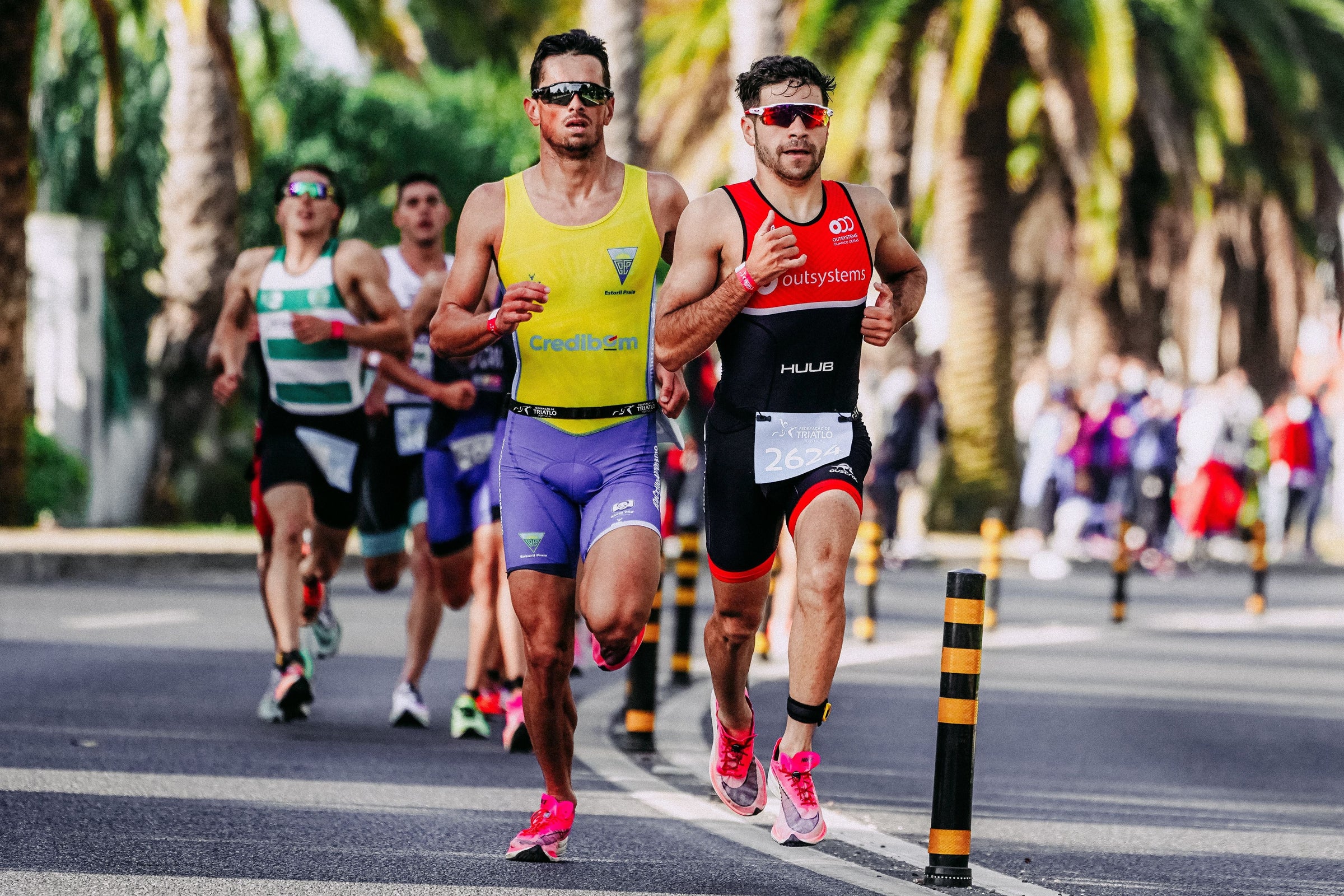 Age-group triathletes racing toward the finish line during a triathlon