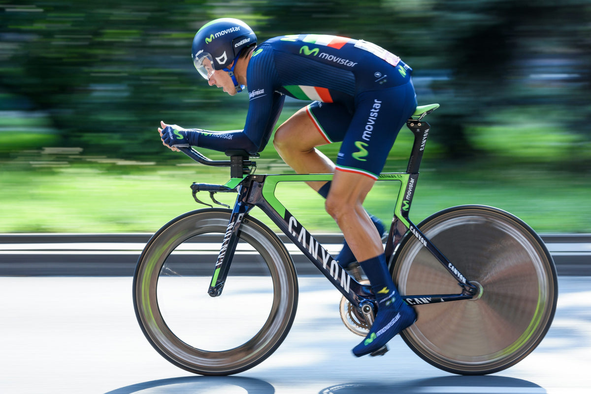 Triathlete riding a time trial bike in an aerodynamic race position
