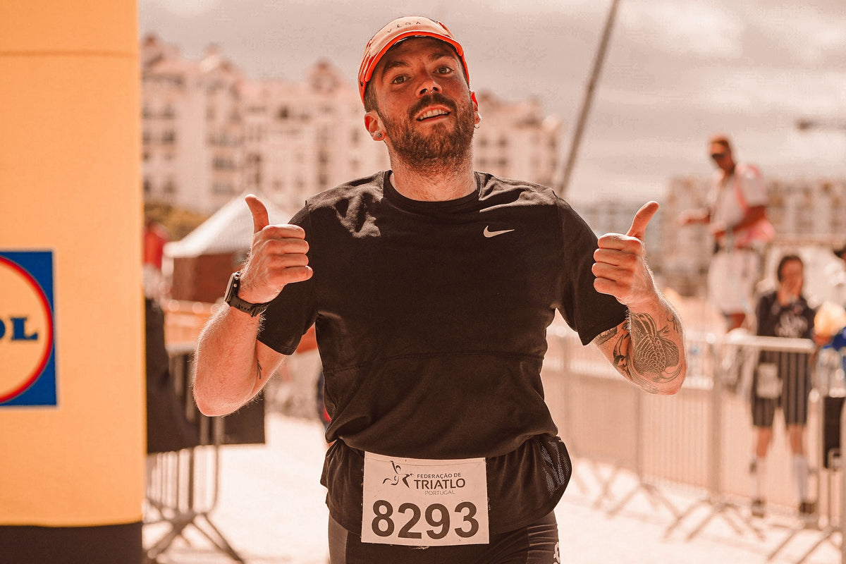 Triathlete finishing a race for a guide to tapering before triathlon