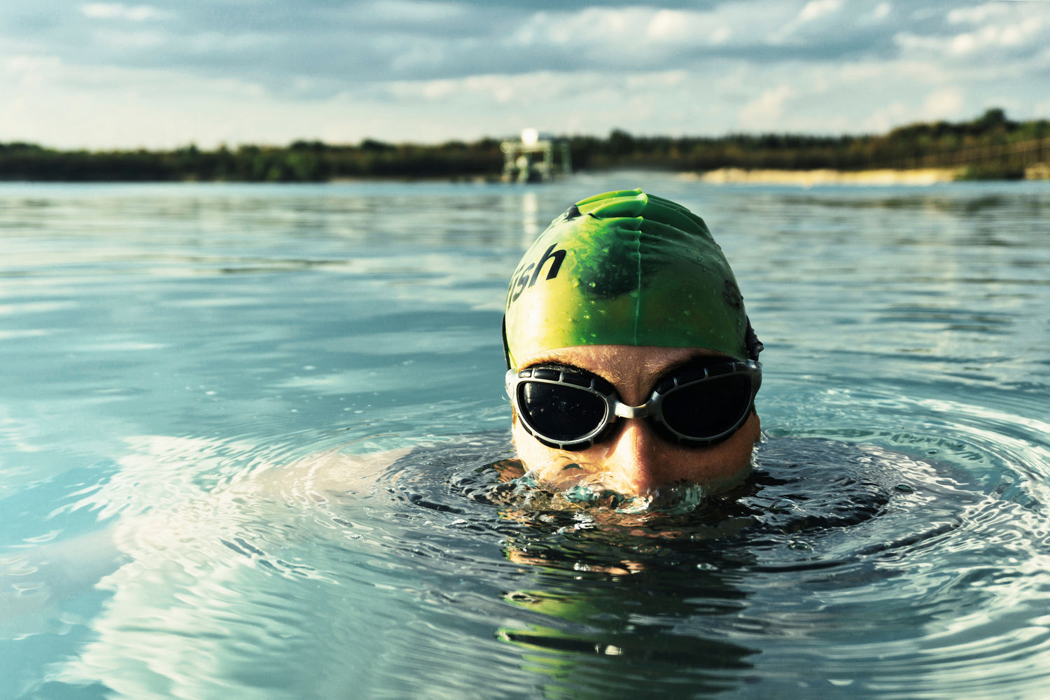 Open-water swimmer wearing goggles and a swim cap