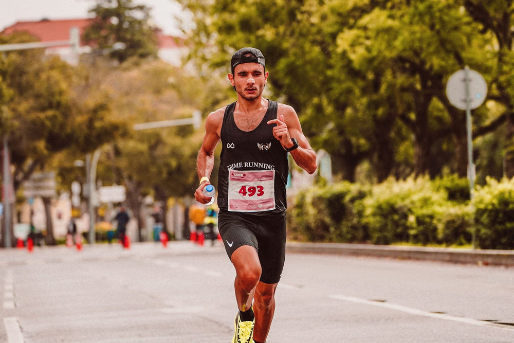 Distance runner competing on a sunny city street