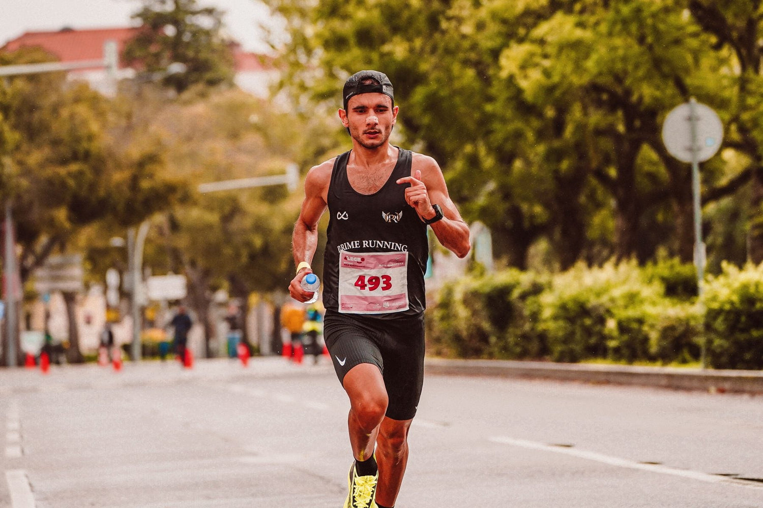 Distance runner competing on a sunny city street
