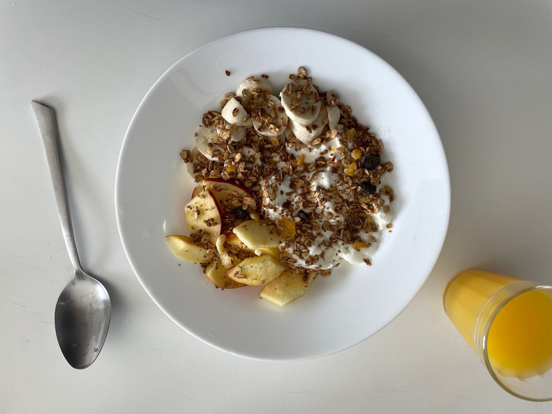 Oatmeal, banana, fruit and orange juice prepared for a race-morning breakfast