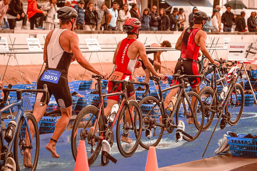 Triathletes moving through a race transition area during an international triathlon event
